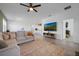 Spacious living room with a large sectional sofa, TV, and view into the adjacent kitchen area at 2837 Darlington Oak Ln, Ocoee, FL 34761