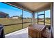 Screened patio with wooden table set overlooking a large grassy backyard at 2837 Darlington Oak Ln, Ocoee, FL 34761