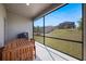 Enclosed patio featuring a wooden table and a view of the spacious, grassy backyard at 2837 Darlington Oak Ln, Ocoee, FL 34761