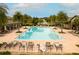 Aerial view showcasing the community pool with palm trees, lounge chairs, and a covered seating area at 2837 Darlington Oak Ln, Ocoee, FL 34761