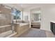 Beautiful bathroom featuring tiled shower with glass doors and soaking tub with a view to the main bedroom at 2843 Maria Isabel Ave, Ocoee, FL 34761