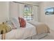 Bright bedroom with neutral tones, large window, and a wall-mounted TV for a relaxing atmosphere at 2843 Maria Isabel Ave, Ocoee, FL 34761