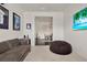 Relaxing room with a comfy sofa and beanbag, with view to the dining room at 2843 Maria Isabel Ave, Ocoee, FL 34761