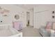 Adorable Bedroom featuring a crib, changing table, and cozy armchair, perfect for a growing Gathering at 2843 Maria Isabel Ave, Ocoee, FL 34761