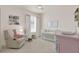 Charming bedroom with pastel accents, cozy recliner, and playful decor, creating a delightful space at 2843 Maria Isabel Ave, Ocoee, FL 34761