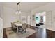 Formal dining room with a large wooden table, seating for six, and decorative lighting at 2843 Maria Isabel Ave, Ocoee, FL 34761