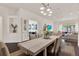 Open dining room featuring a large table, seating for six, with living area in view at 2843 Maria Isabel Ave, Ocoee, FL 34761