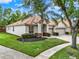 Beautiful home exterior featuring a three-car garage, lush landscaping, and a well-manicured lawn at 2843 Maria Isabel Ave, Ocoee, FL 34761