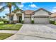Stunning single-story home boasting a well-manicured lawn, a red tile roof, and a convenient three-car garage at 2843 Maria Isabel Ave, Ocoee, FL 34761