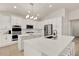 Well-lit kitchen boasts an island with seating and stainless steel appliances at 2843 Maria Isabel Ave, Ocoee, FL 34761
