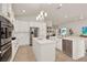 Spacious kitchen features stainless steel appliances, a large center island, and white cabinets at 2843 Maria Isabel Ave, Ocoee, FL 34761