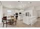 Bright kitchen features an island with seating, modern lighting, and stainless steel appliances at 2843 Maria Isabel Ave, Ocoee, FL 34761