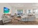 Bright living room featuring a stylish rug, plush seating, and a view into the outdoor patio area at 2843 Maria Isabel Ave, Ocoee, FL 34761