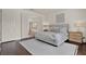 Spacious main bedroom with a view of the bathroom, featuring a comfortable bed and stylish furnishings at 2843 Maria Isabel Ave, Ocoee, FL 34761