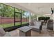 Relaxing screened-in patio with comfortable seating, a ceiling fan, and a view of the lush backyard at 2843 Maria Isabel Ave, Ocoee, FL 34761