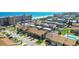 An aerial view of townhomes with ocean views, palm trees, and neighborhood pool at 33 Sea Haven Dr, Ponce Inlet, FL 32127