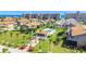 Aerial view of a townhouse complex with swimming pool, palm trees, manicured lawns, and ocean views at 33 Sea Haven Dr, Ponce Inlet, FL 32127