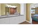 Bathroom vanity features granite countertops, large mirror and is adjacent to the bedroom at 33 Sea Haven Dr, Ponce Inlet, FL 32127