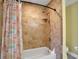 Shower in bathroom features decorative shower curtain and upgraded tile at 33 Sea Haven Dr, Ponce Inlet, FL 32127