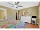 Spacious bedroom has a ceiling fan, walk-in closet, and a dresser with large mirror at 33 Sea Haven Dr, Ponce Inlet, FL 32127