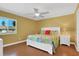 Bright bedroom boasts a ceiling fan, light walls, and a window with neighborhood view at 33 Sea Haven Dr, Ponce Inlet, FL 32127
