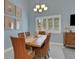 Inviting dining room with blue walls, a wood table, and wicker chairs, illuminated by a chandelier at 33 Sea Haven Dr, Ponce Inlet, FL 32127