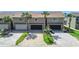 Aerial view of townhomes with garages, palm trees and colorful chairs on patios at 33 Sea Haven Dr, Ponce Inlet, FL 32127