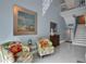 Coastal style decor living room with tile floors, stairway, and beach-themed art and accessories at 33 Sea Haven Dr, Ponce Inlet, FL 32127