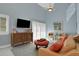 Comfortable living room featuring bright blue walls, a ceiling fan, and shuttered windows for lots of natural light at 33 Sea Haven Dr, Ponce Inlet, FL 32127