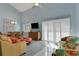 Living room with high ceiling, ceiling fan, sliding glass doors, and adjacent dining area at 33 Sea Haven Dr, Ponce Inlet, FL 32127