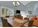 Combined living and dining areas offer great natural light and cozy seating with wicker furniture at 33 Sea Haven Dr, Ponce Inlet, FL 32127