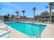 Sparkling community swimming pool surrounded by lounge chairs and palm trees, perfect for relaxation at 33 Sea Haven Dr, Ponce Inlet, FL 32127