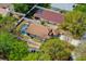 Aerial view of the property showcasing the screened pool, fenced yard, and neighborhood at 33215 Kaylee Way, Leesburg, FL 34788