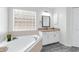 Bathroom featuring bathtub, natural light and granite countertop vanity at 33215 Kaylee Way, Leesburg, FL 34788