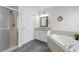 Bright bathroom featuring a shower stall, bathtub and granite countertop vanity at 33215 Kaylee Way, Leesburg, FL 34788