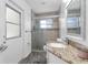 Bathroom featuring a shower stall, granite countertop vanity and a decorative mirror at 33215 Kaylee Way, Leesburg, FL 34788