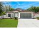 Charming single-Gathering home with well-manicured lawn, a screened garage, and a neutral-colored facade at 33215 Kaylee Way, Leesburg, FL 34788