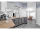 Kitchen with granite counters, gray cabinetry, and modern fixtures open to the dining area at 33215 Kaylee Way, Leesburg, FL 34788