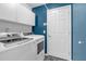Convenient laundry room featuring modern washer and dryer units, with ample storage space at 33215 Kaylee Way, Leesburg, FL 34788