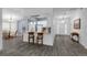 Open-concept living and dining areas feature gray vinyl flooring and lots of natural light at 33215 Kaylee Way, Leesburg, FL 34788