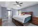 Spacious main bedroom featuring modern ceiling fan, wood floors, and ensuite bathroom access at 33215 Kaylee Way, Leesburg, FL 34788
