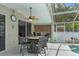 Inviting screened-in patio area with ample seating, a ceiling fan, and a view of the pool at 33215 Kaylee Way, Leesburg, FL 34788