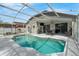 Inviting screened-in pool area with ample seating and lush landscaping. Great for entertaining at 33215 Kaylee Way, Leesburg, FL 34788