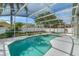 Inviting screened-in pool area with lush landscaping, a pergola, and ample green space at 33215 Kaylee Way, Leesburg, FL 34788