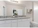 Bathroom featuring a double vanity with granite counters, white cabinets, and a walk-in shower at 3611 Cambridge Brook Dr, Davenport, FL 33837