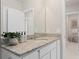 Bright bathroom featuring a granite countertop vanity, stylish fixtures, and a decorative plant at 3611 Cambridge Brook Dr, Davenport, FL 33837