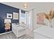 Charming Bedroom with a white crib, modern decor, and soft, natural light from the window at 3611 Cambridge Brook Dr, Davenport, FL 33837