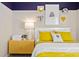 Charming bedroom featuring unique wall decor, a stylish lamp, and bright, colorful bedding at 3611 Cambridge Brook Dr, Davenport, FL 33837