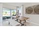 Dining area with large glass doors to the outside, a dining table for six, and stylish décor at 3611 Cambridge Brook Dr, Davenport, FL 33837