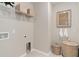 Clean laundry room with wire shelving, wicker baskets, and neutral wall decor, maximizing space at 3611 Cambridge Brook Dr, Davenport, FL 33837